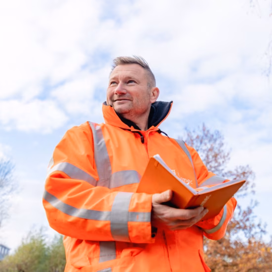 An inspector performs inspection and audit tasks on-site and records findings.
