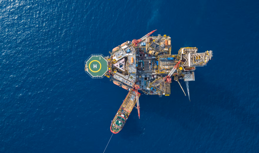 Aerial view of an offshore oil or gas platform at sea, seen from above.