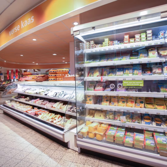 Refrigerated display case with packaged food items in a supermarket.
